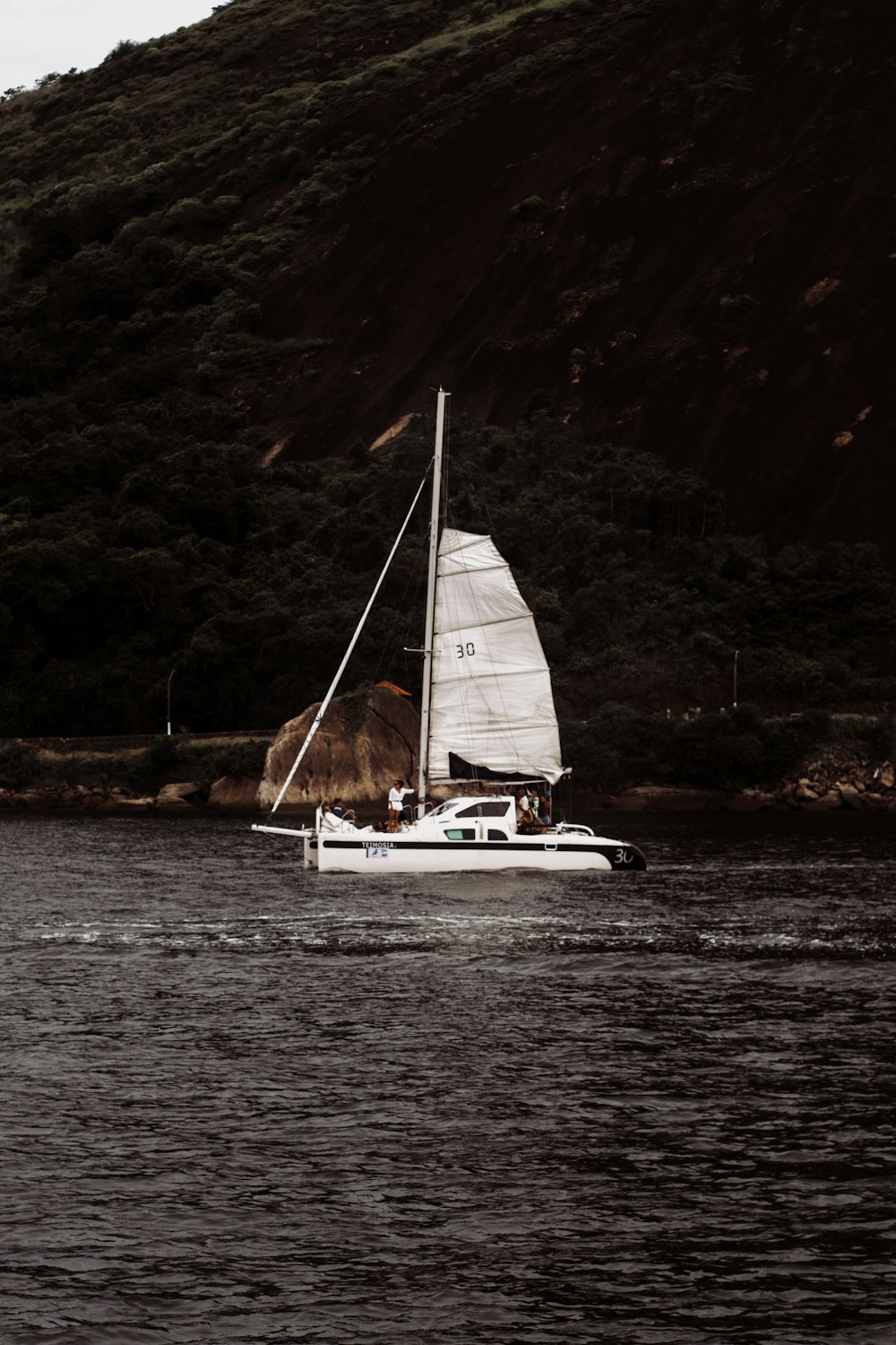 a sailboat sailing on a body of water