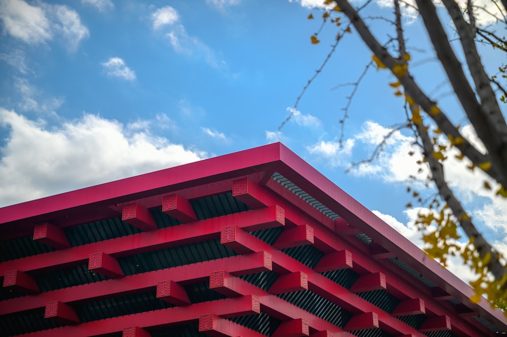 a red building with a tree in front of it