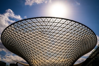 a large metal structure with a sky background
