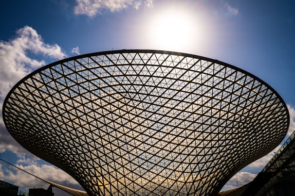 a large metal structure with a sky background