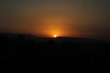 A serene sunset behind a city skyline, symbolizing the end of a busy day