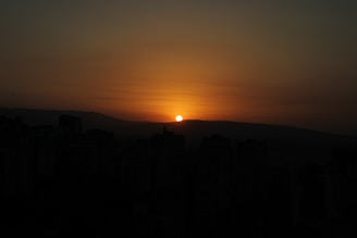 A serene sunset over a city skyline, symbolizing hope.
