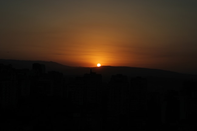 Sunset over the city skyline, highlighting the day's end.
