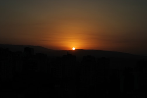 A serene sunset over a city skyline, symbolizing hope.