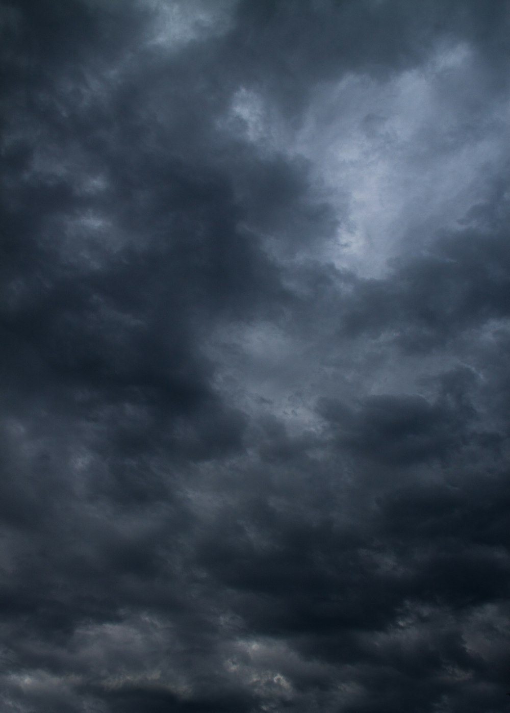 a plane flying through a dark cloudy sky