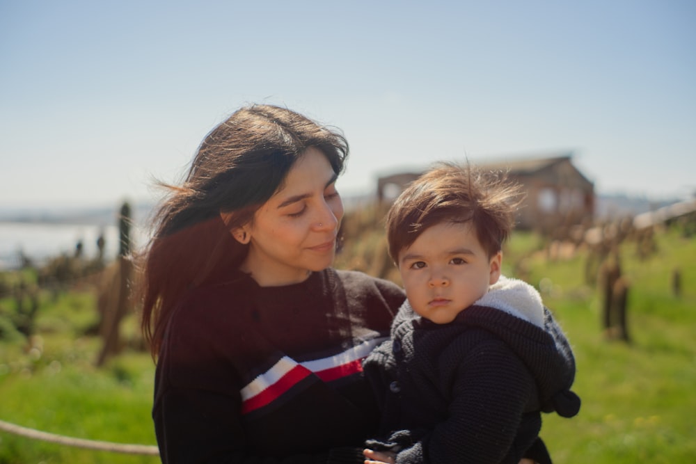 a woman holding a small child in her arms