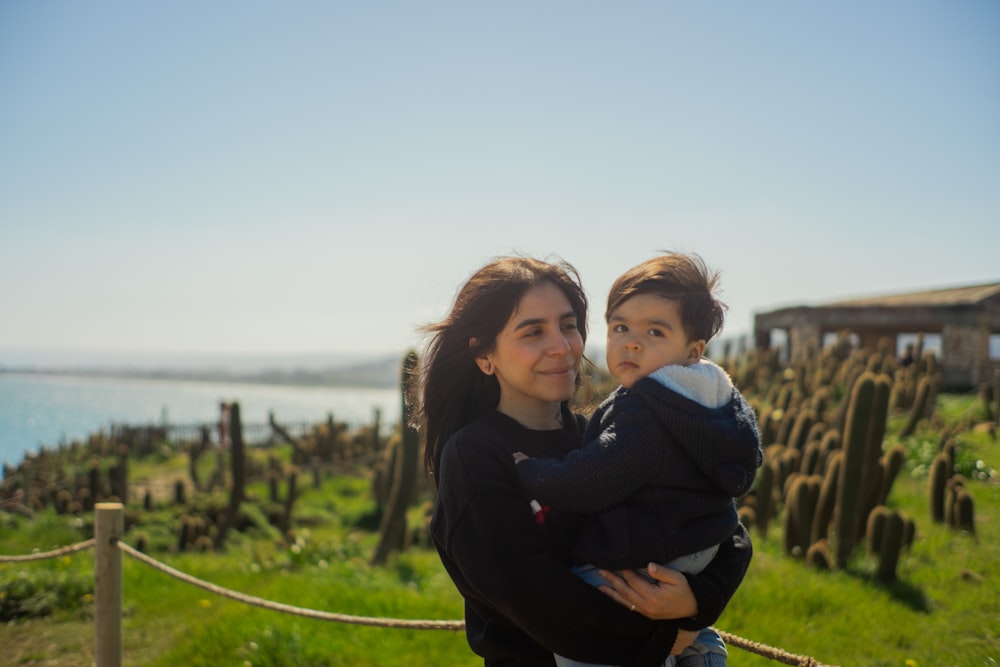 a woman holding a small child in her arms