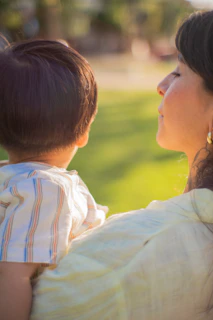 a woman holding a small child in her arms