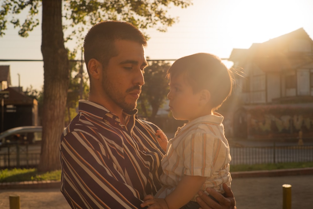 a man holding a little girl in his arms