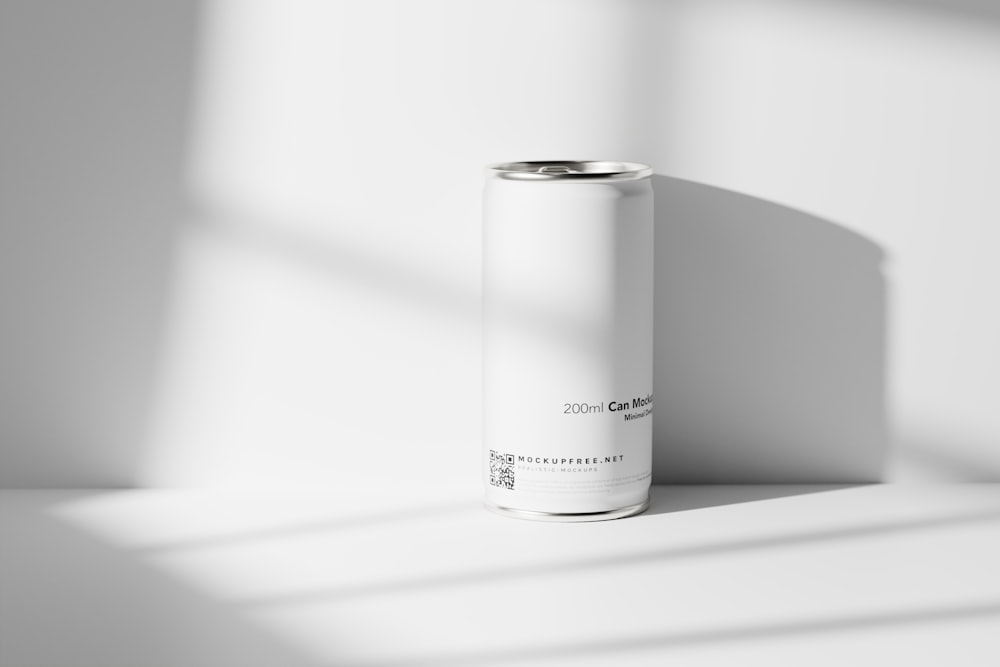 a can of soda sitting on a white surface