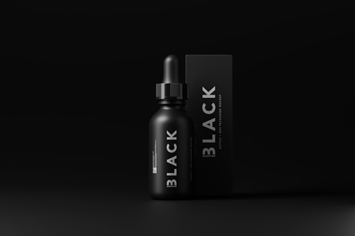 A sleek black dropper bottle is placed next to a black box with the word 'BLACK' prominently displayed. The minimalistic design features dark tones and smooth surfaces that emphasize premium aesthetics.