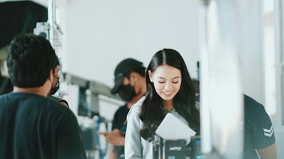 A group photo of diverse artists smiling together in a creative workspace.