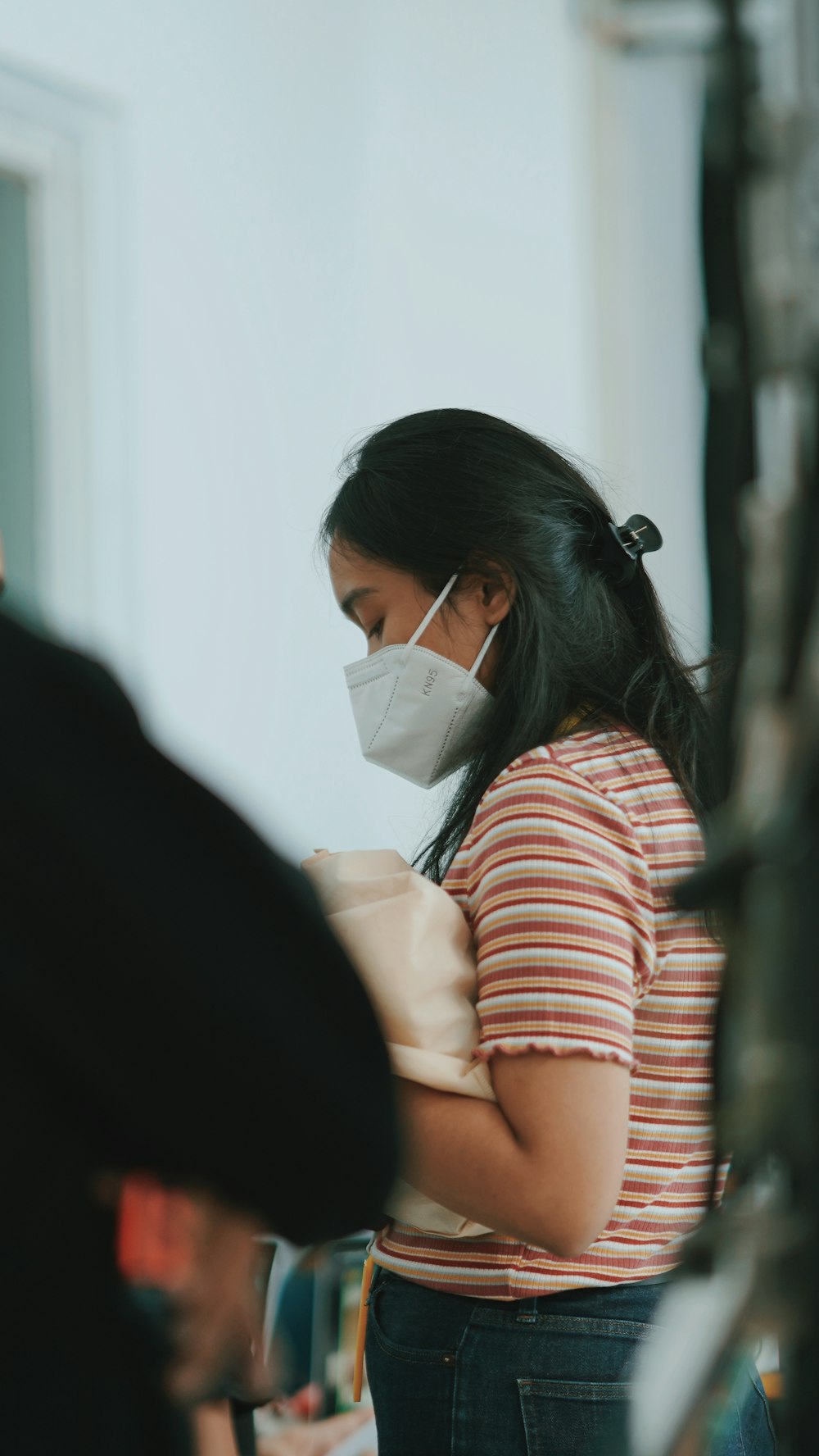 a woman wearing a face mask in a room