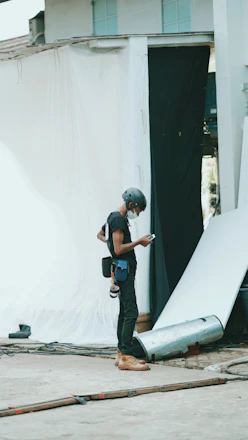 A professional engineer inspecting a construction site with safety gear in a modern urban setting.