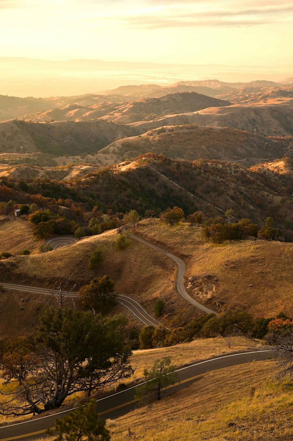 a scenic view of a winding road in the mountains