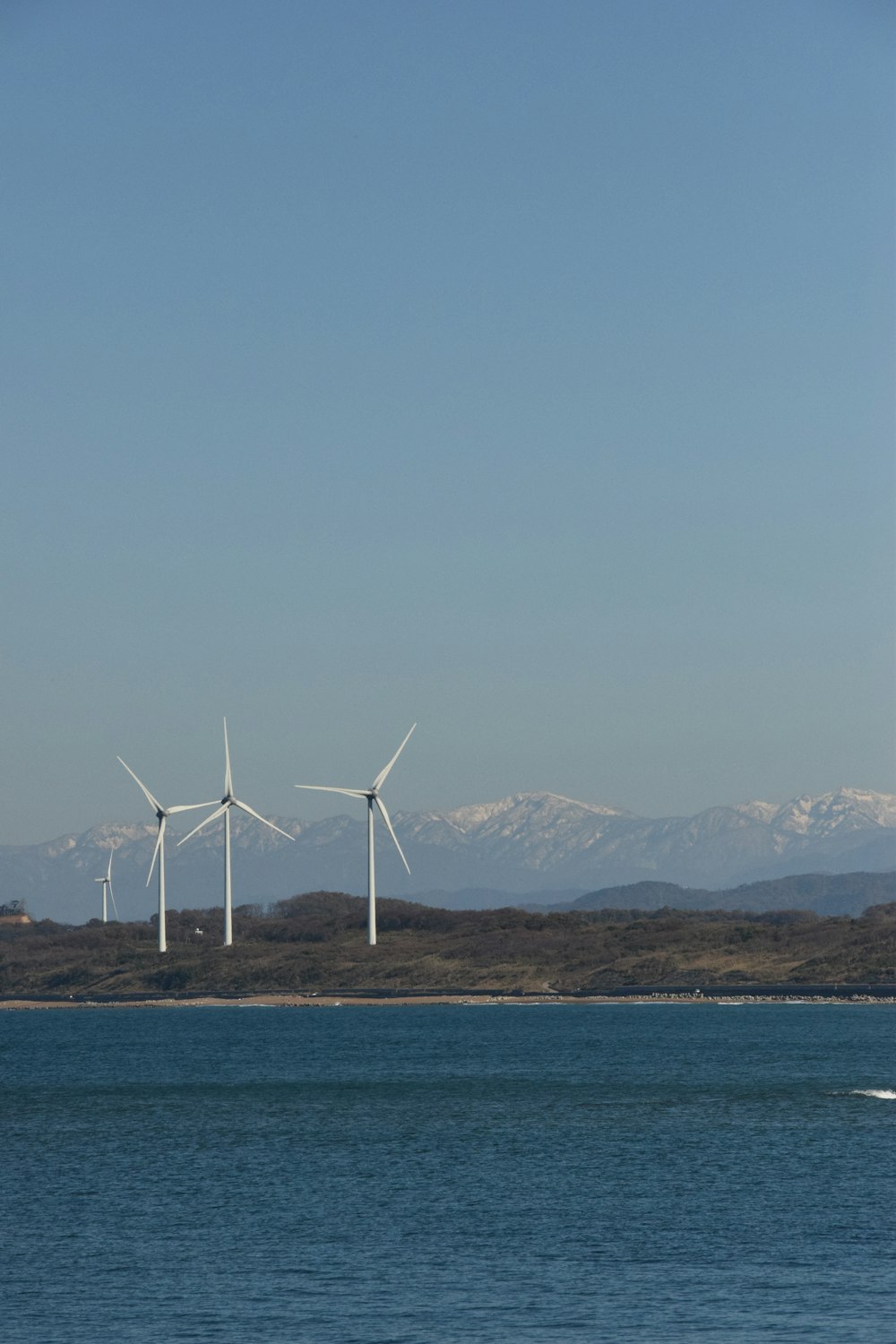 a wind farm in the middle of a body of water