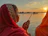 A serene photo of a pilgrim performing pinddaan by the Falgu river at sunset, with the Vishnupad temple softly glowing in the background.