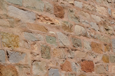 Outdoor stone wall made from sandstone blocks with warm earthy tones.