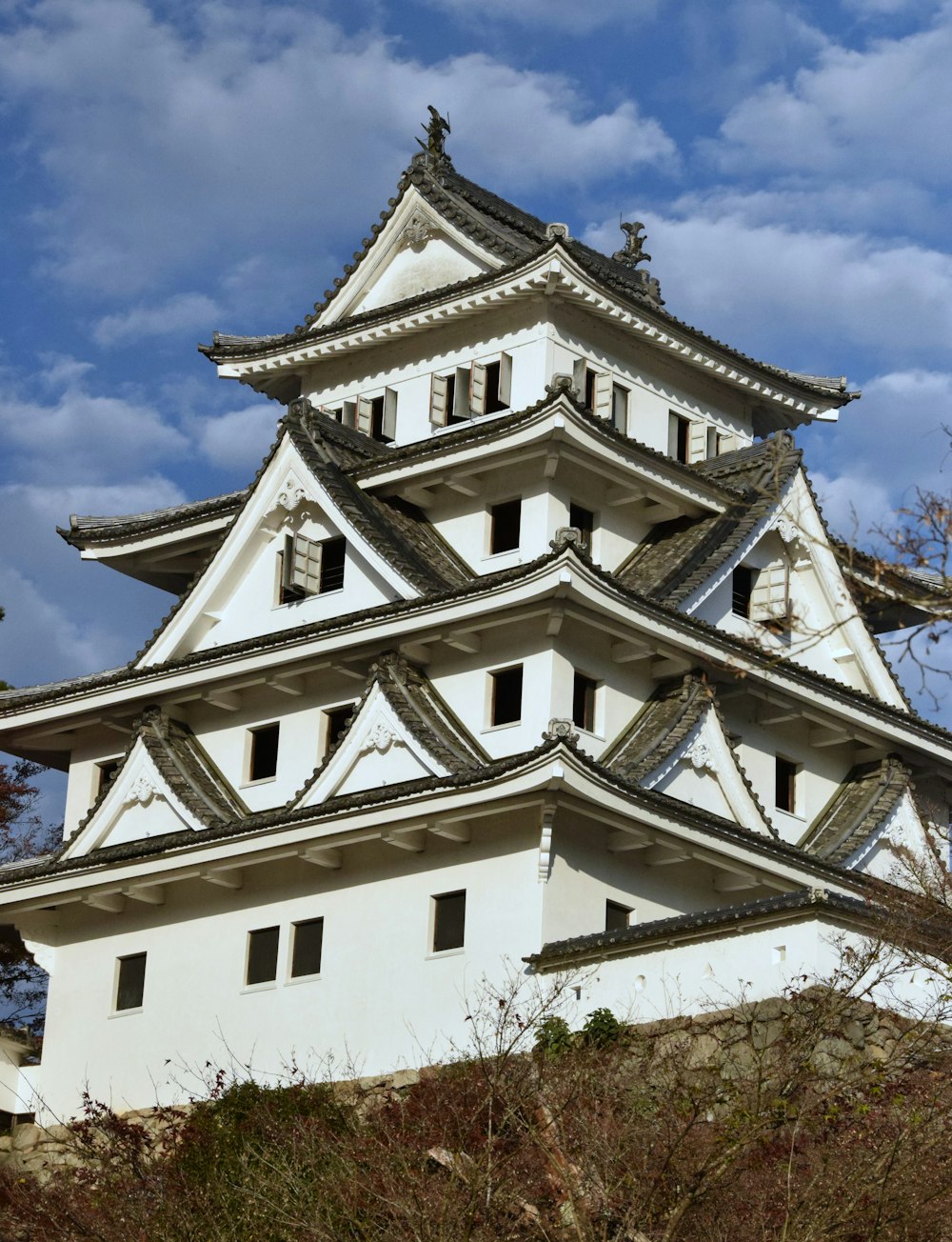 a tall white building sitting on top of a hill