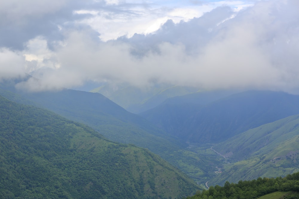 a view of a valley with mountains in the background