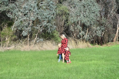 A cozy family wearing matching outfits in a park.
