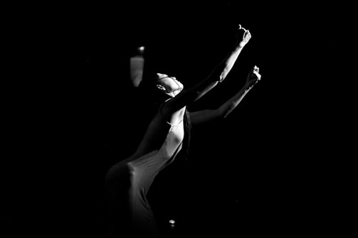 a woman in a white dress holding a tennis racquet