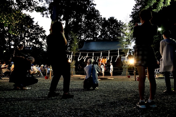 A community gathering in a rural area illuminated by clean solar energy at dusk.