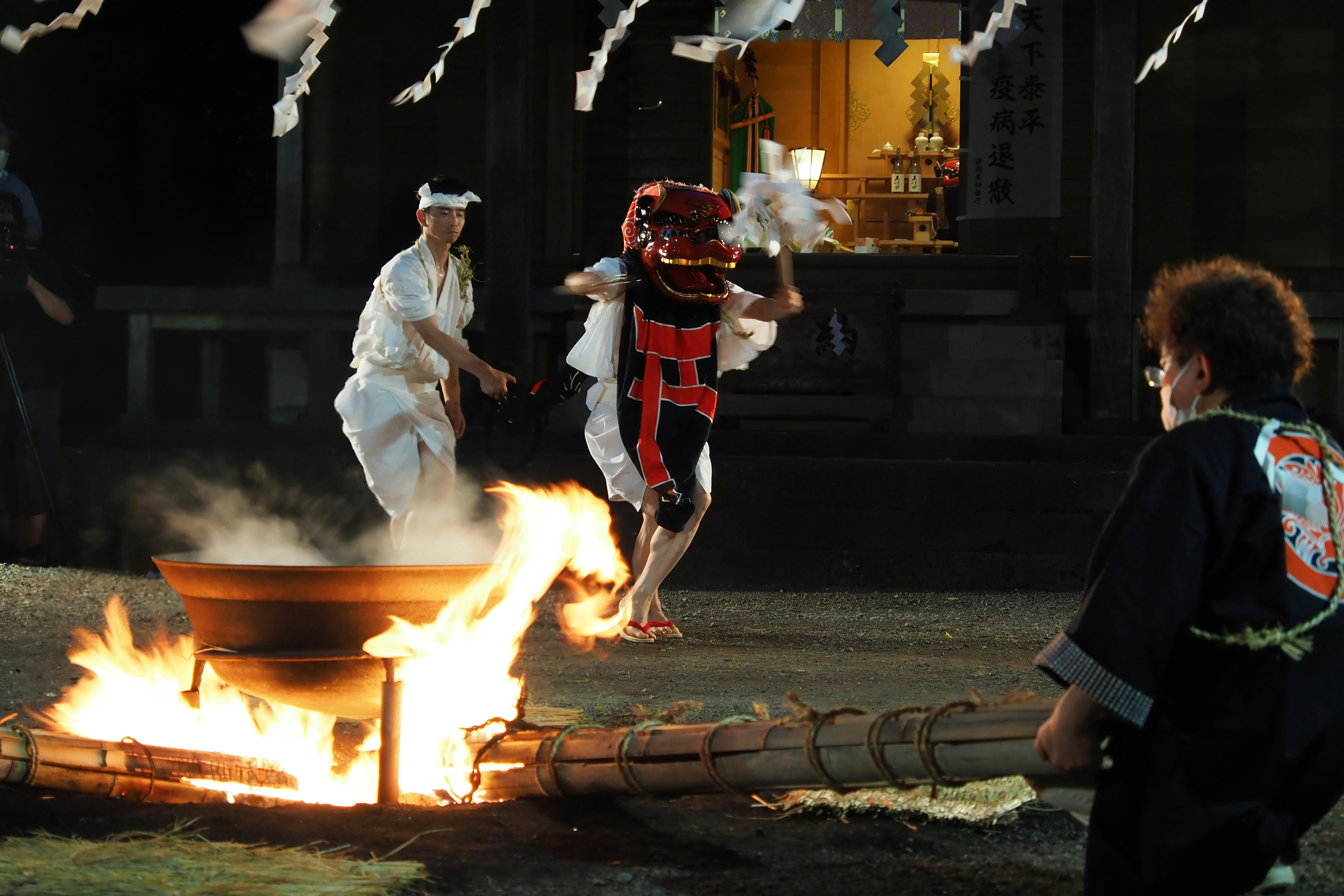 a group of people standing around a fire pit