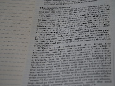 Close-up view of a page from a book featuring religious text. The page is open to a section titled 'The Seventy 'Sevens''. The text appears to discuss a vision and prophecy given by an angel named Gabriel, making references to 'seventy sevens' and religious concepts such as understanding, vision, and righteousness. The text is laid out in paragraph form with a clear font for readability.