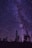a night sky filled with stars and trees