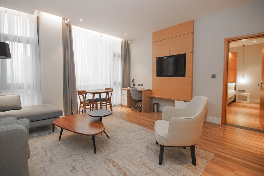 a living room filled with furniture and a flat screen tv