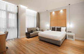 Modern bedroom furnished with sleek rental furniture and soft lighting