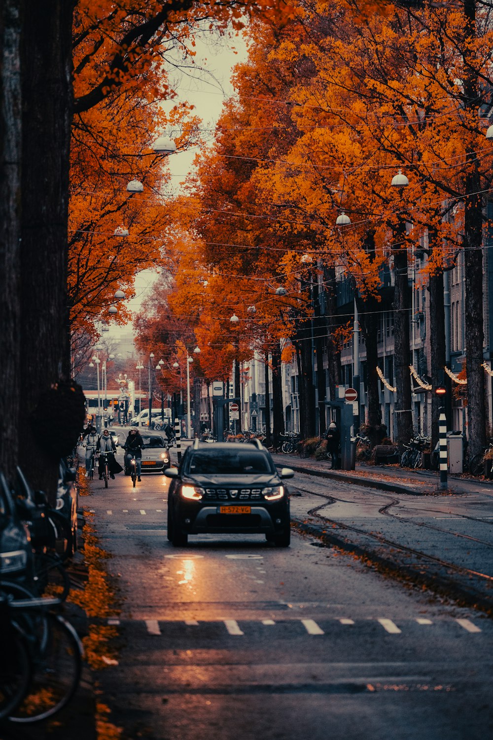 a car driving down a street next to tall buildings