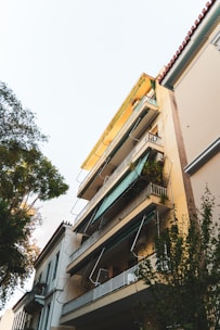 Exterior view of the 10-story residential building in Kipé with balconies and surrounding greenery.