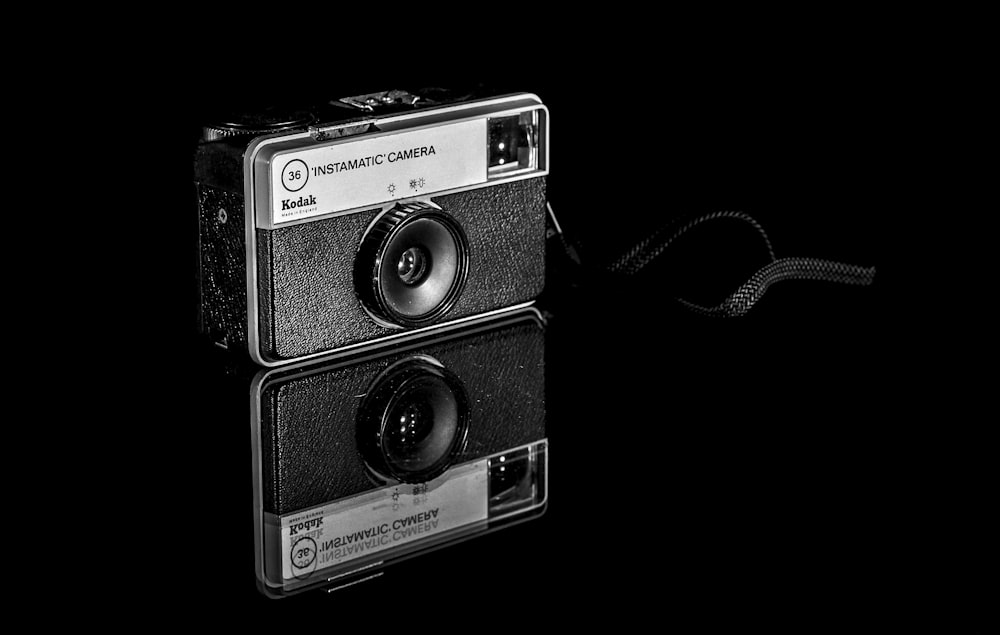 a black and white photo of an old camera