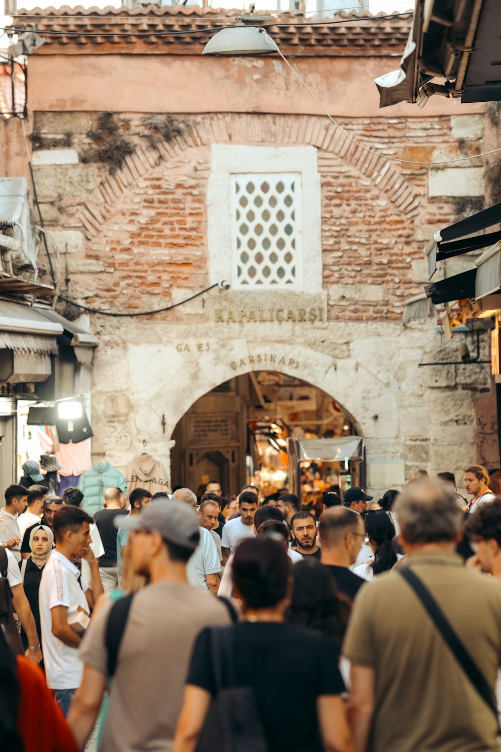 a crowd of people walking down a street next to a building