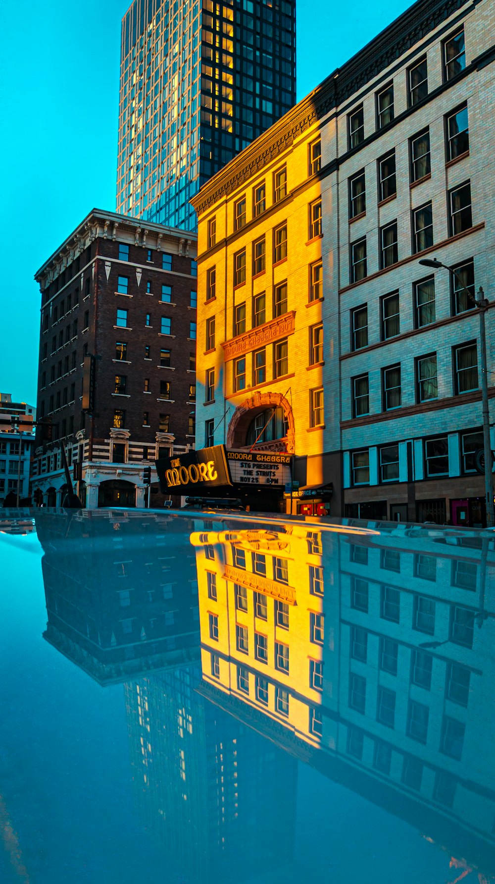 a reflection of a building in a pool of water