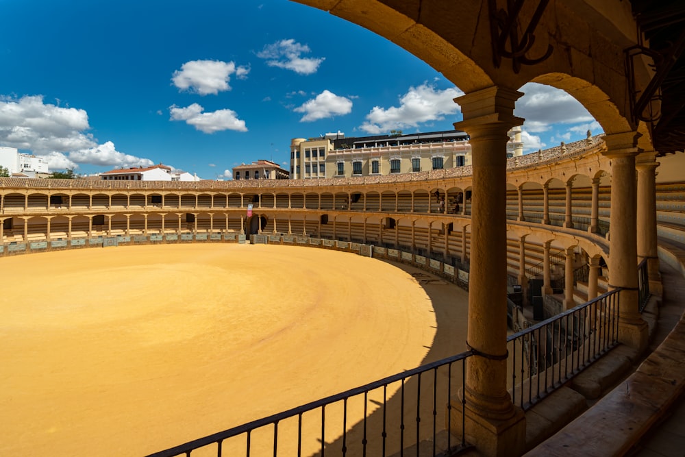 a bull ring in a large building with a sky background