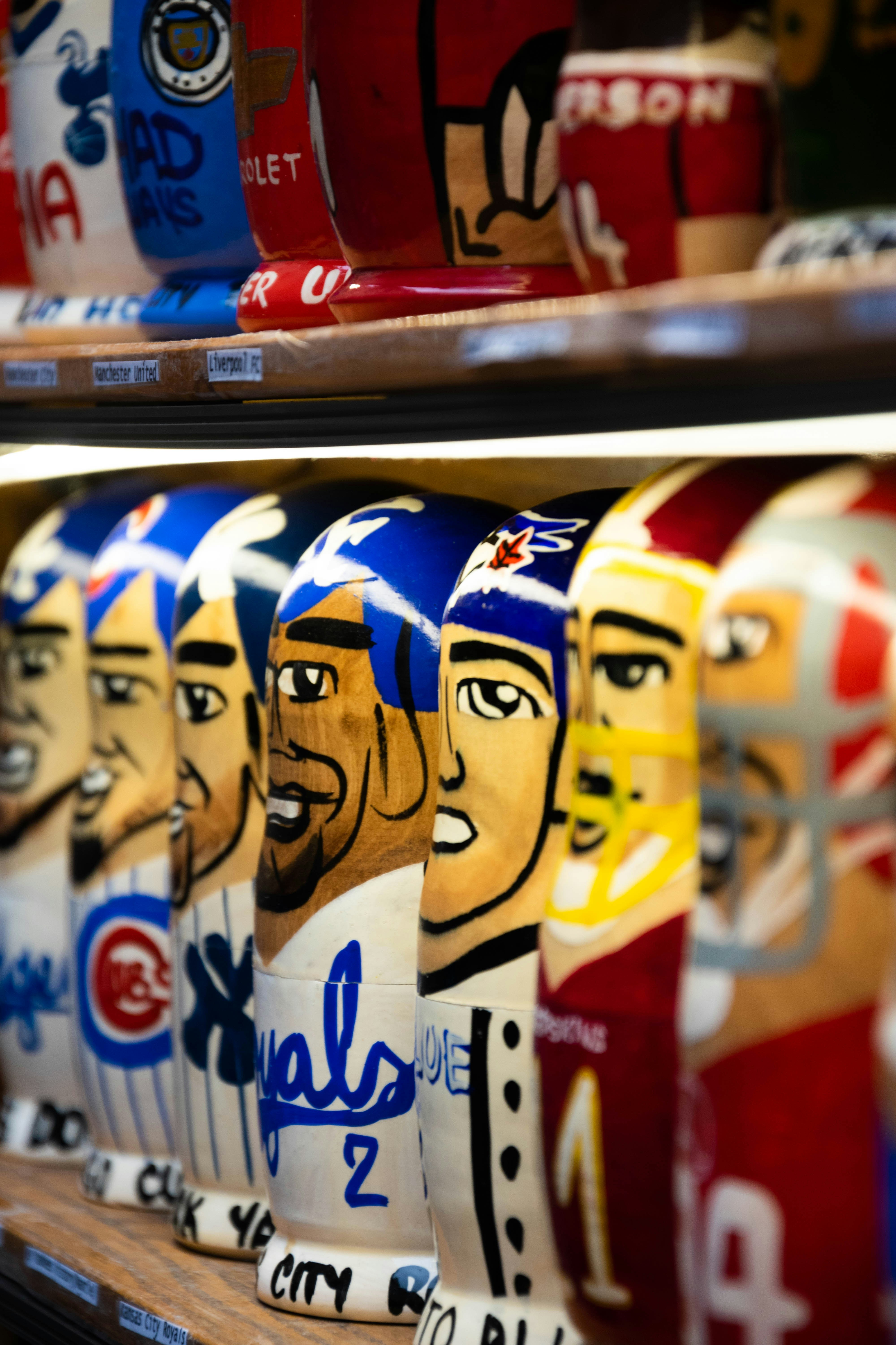 a row of baseball caps sitting on top of a shelf