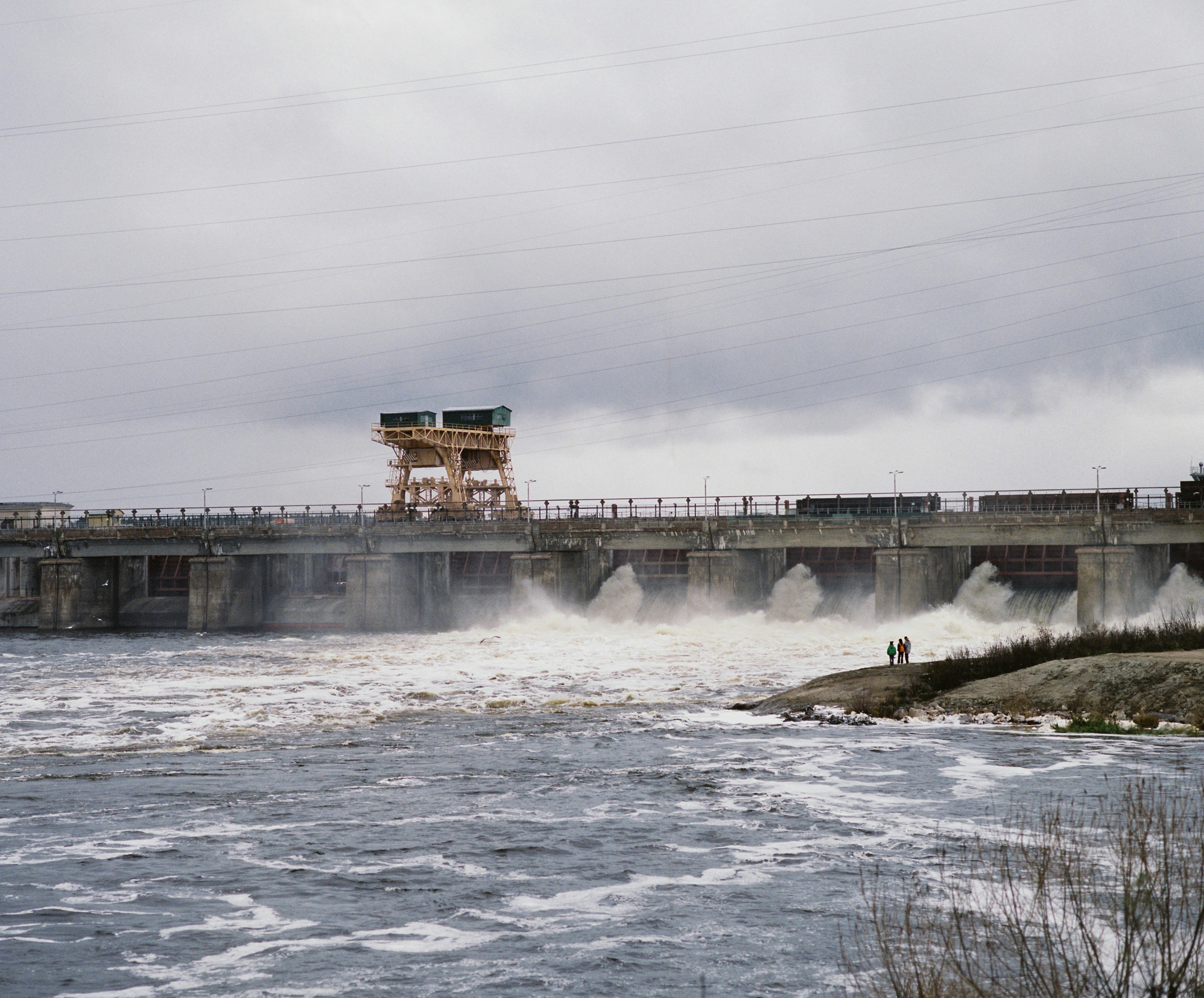 ein großes Gewässer mit einer Brücke im Hintergrund