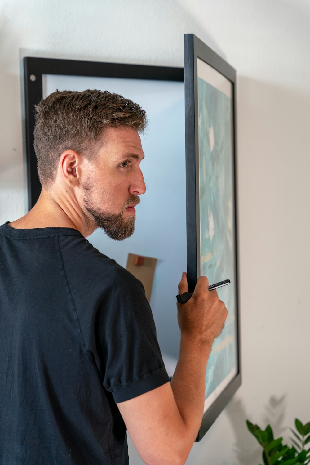 a man writing on a board with a marker