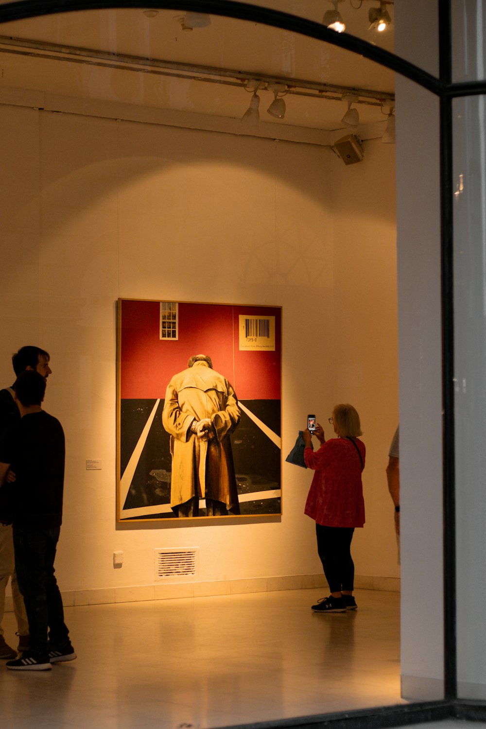 a group of people standing in front of a painting