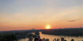 A scenic view of the river at sunset, symbolizing the connection between the living and their ancestors.