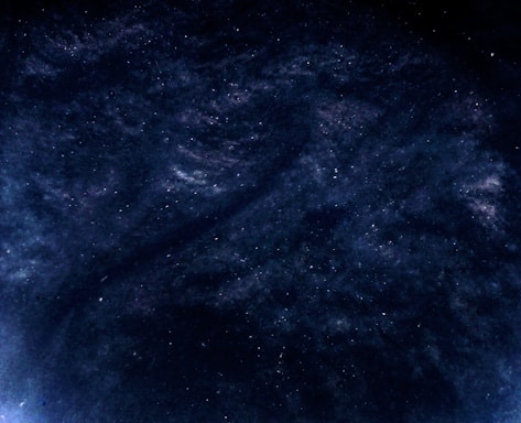 Ethereal digital cloud with shimmering silver light beams piercing through a dark cosmic sky.