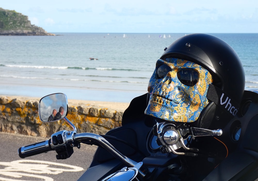 a person wearing a skull mask on a motorcycle