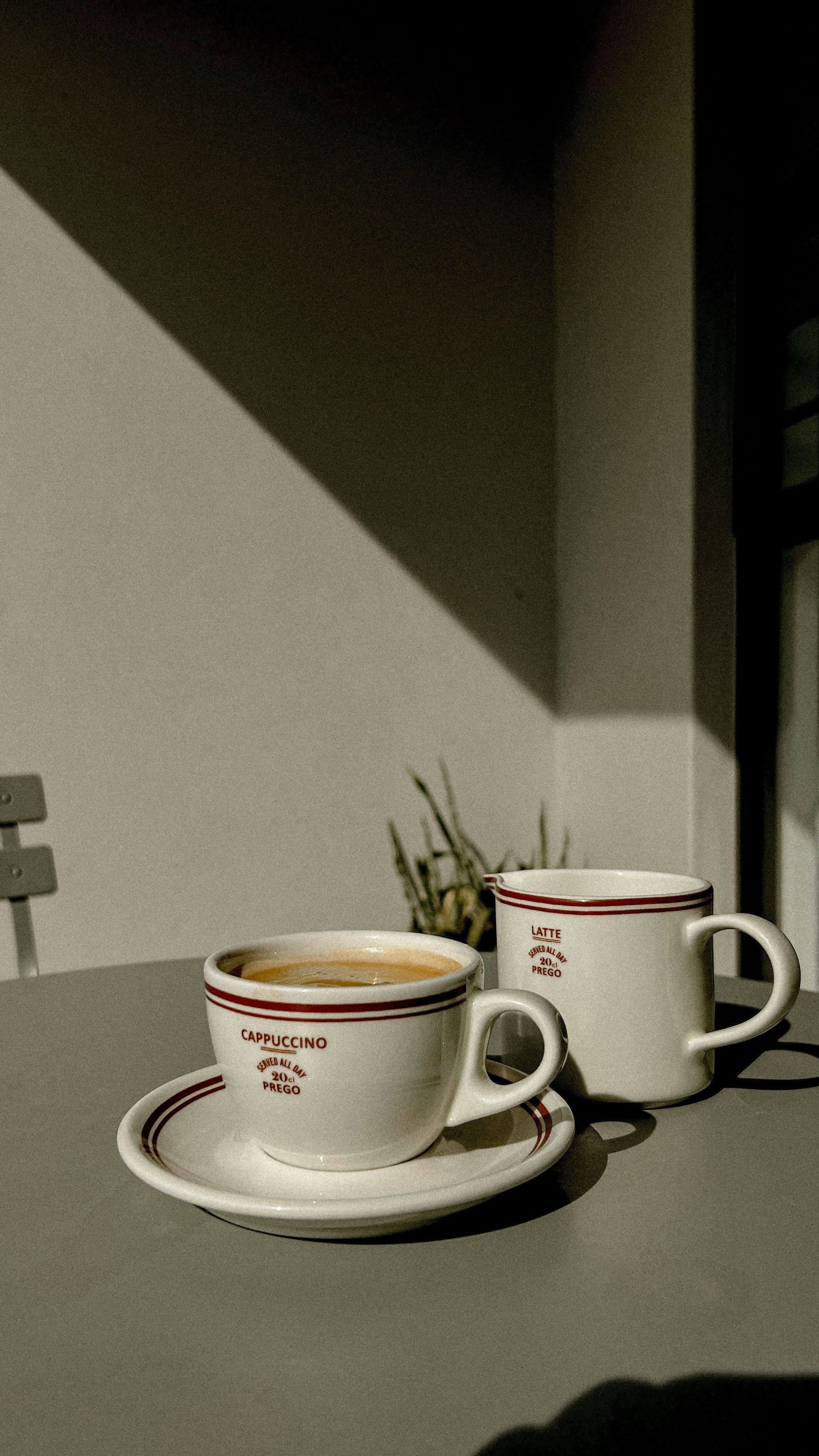 two cups of coffee sitting on top of a table