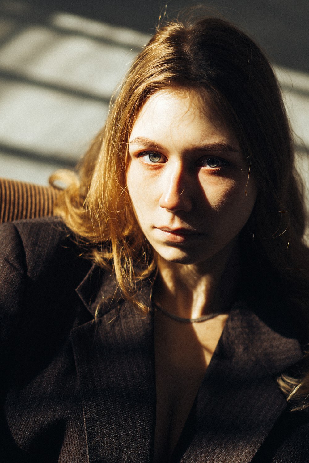 a woman sitting in a chair looking at the camera