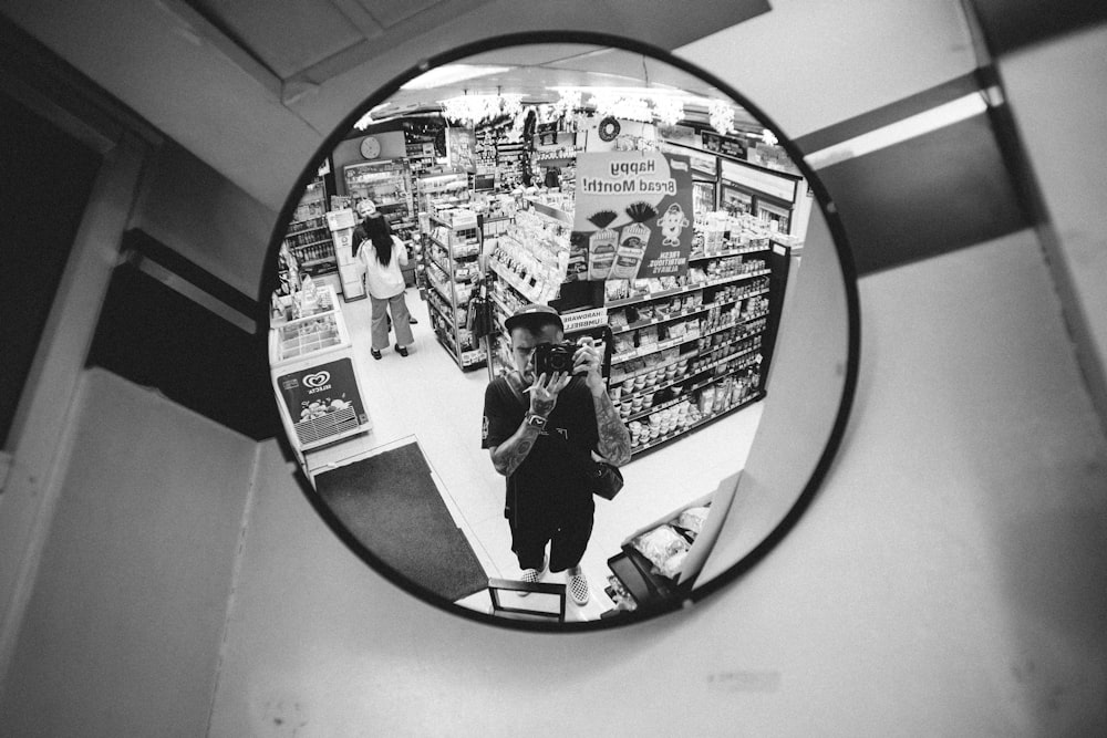 a person standing in front of a mirror in a store