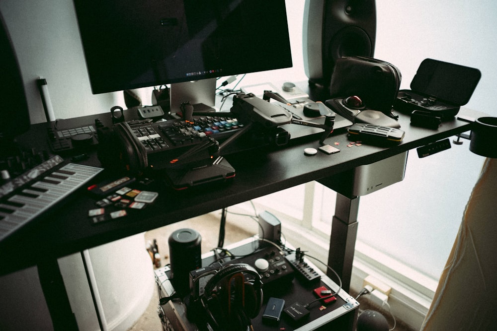 a desk with a lot of electronics on it