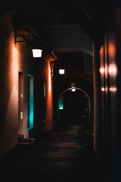 A mysterious alleyway illuminated by soft streetlights.